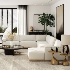 a living room filled with white furniture and large windows