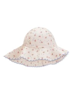 a child's white hat with pink flowers on it