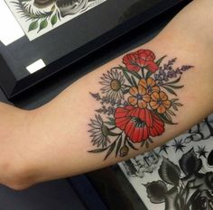 a person with a flower tattoo on their arm