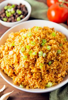 a bowl filled with rice, beans and tomatoes