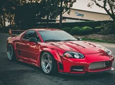 a red sports car is parked on the street