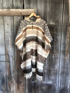 Native style alpaca/lambswool mix poncho Brown lambswool/alpaca wool poncho Etno style wool poncho very warm and breathable Blanket poncho One size fits fashionably for most everyone, short or tall, big or small. This piece is versatile for both Men's & Women's outdoor fashion, and can be used insider in cooler winter weather to keep warm while reading on the couch. CARE: Hand-wash and hang to dry, light iron if needed, or dry clean. MEASURES: Length at the front of the neckline to the botto Brown Alpaca Poncho For Winter, Traditional Alpaca Poncho For Fall, One Size Long Sleeve Alpaca Poncho, Casual Brown One-size Poncho, Cozy Brown Alpaca Poncho, Womens Outdoor Fashion, Blanket Poncho, Wool Poncho, Ladies Poncho