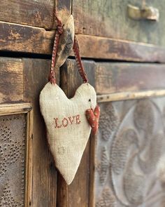 a heart hanging on the side of a wooden door