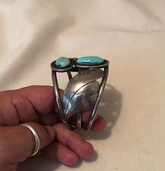 "Large Vintage Native American Indian Sterling Silver And Bright Blue Turquoise Unisex Cuff Bracelet With Two Stones $595.00 A collectable statement piece for the larger wrist. This vintage Native American sterling silver and bright blue turquoise cuff measures approximately 2 3/4\" across on the inside and 2 1/8\" from front to back inside. The total weight is 62.5 grams. The base of the cuff is quite traditional with three strips of half round wire soldered together side by side at the ends an Adjustable Turquoise Bangle For Collectors, Unique Blue Bangle Cuff Bracelet, Unique Blue Bangle, Southwestern Blue Cuff Jewelry, Blue Artisan Cuff Jewelry, Artisan Blue Cuff Jewelry, Elegant Turquoise Cuff Bracelet, Artisan Blue Cuff Bracelet, Turquoise Bangle Cuff Bracelet For Formal Occasions