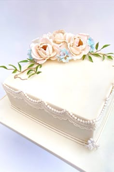 there is a white cake with flowers on it