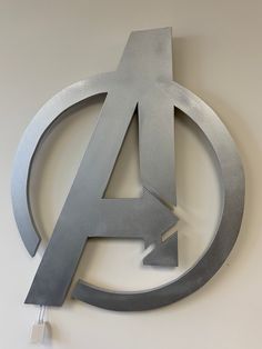 the avengers symbol is mounted on the wall