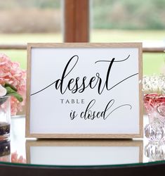 a sign that says dessert table is closed on top of a table with vases and flowers