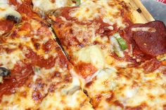 a pizza with pepperoni, green peppers and cheese