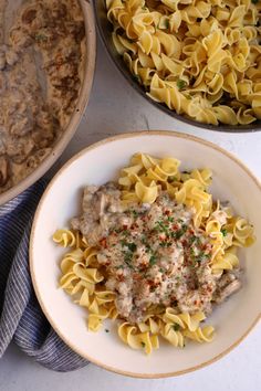 two bowls filled with pasta next to a casserole dish