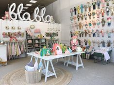 a room filled with lots of stuffed animals on display next to a sign that says hello