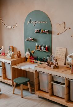 a child's playroom with toys and crafting supplies on the desks