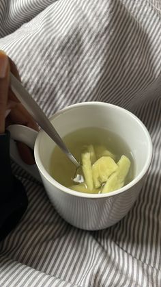 a person is cutting into some food in a bowl