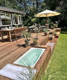 a wooden deck with an above ground swimming pool and patio furniture on the other side