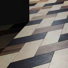 a wooden floor with black and white lines on it's side, next to a tv