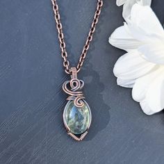 This pendant has a beautiful green moss aquamarine centerpiece, wrapped in bare copper wire that has been oxidized and polished. It measures 1.5 x .5 inches, making it a small-sized pendant. The necklace chain is also oxidized and polished copper and comes in a variety of lengths to suit your needs. STONE INFO:  This jewelry piece is made with a beautiful green form of aquamarine, referred to as moss aquamarine. Aquamarine is named from the Latin "water of the sea", and is in the beryl mineral f Artisan Jewelry Necklaces, Moss Aquamarine, Wrap Gift, Boho Handmade, Wrap Jewelry, Handmade Boho, Wire Wrapped Pendant, Copper Jewelry