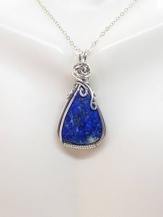 📌Handmade Item📌 💘Lapis Lazuli Sterling Silver Wire Wrapped Pendant is crafted using a Argentium fine silver wire that is wrapped around a gorgeous deep blue lapis lazuli stone with a rose in the middle. 💘This beautiful pendant is 1.62 inches high by .79 inches in width. Comes with either a free 18 or 20-inch sterling silver starter chain or a waxed leather cord as a gift for your purchase. 💘Aesthetic Jewelry will make a timeless gift for her and the perfect romantic gift. All pendants are s Handmade Blue Lapis Lazuli Necklace, Handmade Silver-plated Wire Jewelry, Unique Sapphire Necklace As Gift, Unique Sapphire Necklace For Gift, Handmade Lapis Lazuli Necklaces, Wire Wrapped Silver-plated Jewelry, Artisan Lapis Lazuli Necklace Gift, Silver Lapis Lazuli Round Pendant Jewelry, Unique Handmade Silver-plated Wire Jewelry