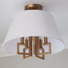 a close up of a light fixture with a white shade