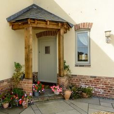 the front entrance to a house with potted plants