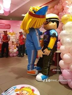 a couple of cartoon characters standing next to each other in front of balloons and plates