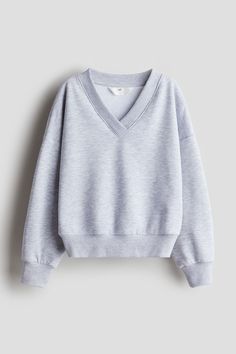 Sweatshirt with a soft  brushed inside. V-neck with wrapover front  dropped shoulders  and ribbing at neck  cuffs  and hem. H&m Sweatshirt, Cozy Tops With Ribbed Waistband For Fall, Fall Solid Tops With Ribbed Waistband, Casual V-neck Winter Sweatshirt, Solid Tops With Ribbed Waistband For Fall, Sporty H&m Tops For Fall, H&m Relaxed Fit Sweatshirt For Winter, H&m Long Sleeve Sweatshirt For Spring, Trendy Loungewear Tops With Ribbed Collar