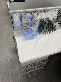 a display case filled with lots of different types of pine cones on top of white cloth