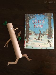 the book stick man is next to an empty roll of toilet paper