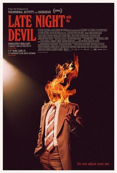 a man in a suit and tie with fire coming out of his mouth on a movie poster