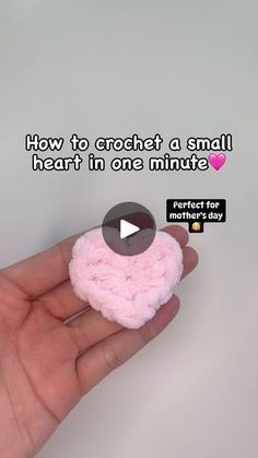 someone is holding a small pink crochet heart in their left hand with the text, how to crochet a small heart in one minute perfect for mother's day