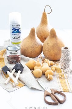 some pears and other items are sitting on a towel next to a pair of scissors