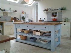 a kitchen with an island in the middle of it and lots of bowls on top