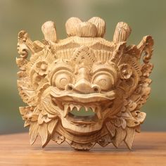 a wooden mask sitting on top of a table