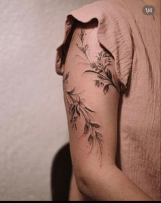 a woman with a flower tattoo on her arm