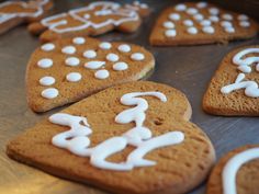 cookies with white icing are arranged on a baking sheet