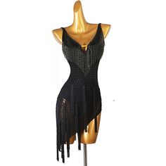 a mannequin wearing a black dress with fringes