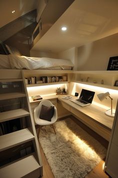 a bedroom with a loft bed, desk and computer on the shelf next to it