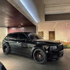 a black suv is parked in a building