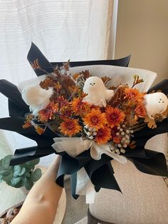 a bouquet of flowers with two white birds on it