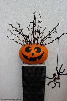 a pumpkin planter sitting on top of a radiator next to a spider