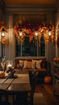 a living room filled with lots of furniture next to a window covered in fall leaves