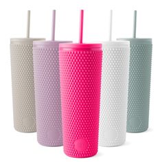 four different colored tumblers with straws in each one, all lined up against the same color