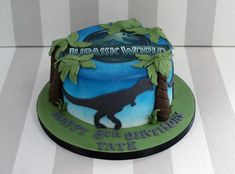 a birthday cake with a dinosaur on it