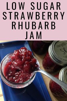 a jar of low sugar strawberry rhubarb jam on a blue tray