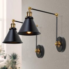 two black and gold wall lights in a room