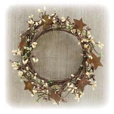 a wreath with leaves and flowers on it