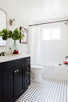 a bathroom with black and white tile flooring