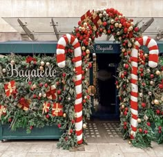 an entrance decorated for christmas with candy canes and decorations on the front door to bagatelle