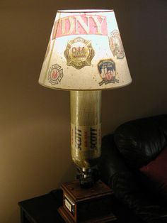 a lamp that is sitting on top of a table next to a black leather couch