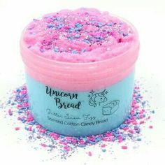 a pink and blue tub filled with sprinkles on top of a white surface