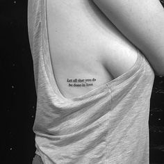 the back of a woman's shoulder with a quote on it