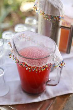 a pitcher filled with liquid sitting on top of a table